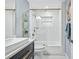 This bathroom features blue walls, a vessel sink, and a tub and shower at 75 Spyglass Aly, Placida, FL 33946