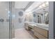 Modern bathroom featuring double sinks, walk-in shower, and contemporary lighting at 75 Spyglass Aly, Placida, FL 33946