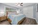 Charming bedroom with wooden floors, light blue walls, and a window at 75 Spyglass Aly, Placida, FL 33946