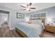 Charming bedroom with wooden floors, light blue walls, and a window at 75 Spyglass Aly, Placida, FL 33946