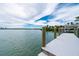 Waterfront view of a white dock extending into tranquil waters with scenic coastal views at 75 Spyglass Aly, Placida, FL 33946