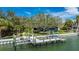 Waterfront view featuring a private dock, boat lift and meticulously kept yard at 75 Spyglass Aly, Placida, FL 33946