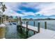 A waterfront dock with a boat lift offers direct access to the serene open water and coastal views at 75 Spyglass Aly, Placida, FL 33946