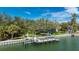 Exterior shot of waterfront home featuring a private dock and boat lift at 75 Spyglass Aly, Placida, FL 33946