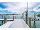 Private dock featuring a boat lift and seating at 75 Spyglass Aly, Placida, FL 33946