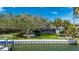 Back yard view featuring a beautiful tree with a swing and a screened-in pool at 75 Spyglass Aly, Placida, FL 33946