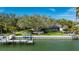 Waterfront home with private dock, lush landscaping, and screened in lanai with a pool at 75 Spyglass Aly, Placida, FL 33946
