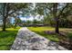 Lush front yard and winding driveway leading to a beautiful home at 75 Spyglass Aly, Placida, FL 33946