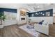 Bright living room with a stone fireplace, wood-look flooring, and stylish decor at 75 Spyglass Aly, Placida, FL 33946
