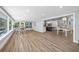 Spacious living room with wood-look tile, bar-height table, and open view to the kitchen at 75 Spyglass Aly, Placida, FL 33946