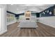 Cozy living room featuring stone fireplace, wood-look flooring, and stylish decor at 75 Spyglass Aly, Placida, FL 33946