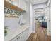 This hallway features a mud room design with white cabinets and tile floors at 75 Spyglass Aly, Placida, FL 33946