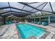 A screened pool offers plenty of space for seating, a spa, and water views at 75 Spyglass Aly, Placida, FL 33946