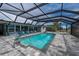 The pool is inviting, with a screened-in enclosure and lounging furniture at 75 Spyglass Aly, Placida, FL 33946