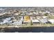 Panoramic aerial view of a residential area with canal access, pools, and neatly arranged homes under a bright sky at 944 Genoa Ct, Punta Gorda, FL 33950