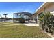 Lush backyard with a covered pool and access to waterfront views, perfect for relaxation and entertaining at 944 Genoa Ct, Punta Gorda, FL 33950