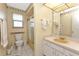 Cozy bathroom featuring a vanity, mirror, and shower with glass doors for a clean and functional design at 944 Genoa Ct, Punta Gorda, FL 33950