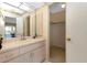 Well-lit bathroom vanity area with view to lanai at 944 Genoa Ct, Punta Gorda, FL 33950