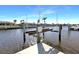Detailed view of a boat lift system on a private dock, facilitating easy boat storage and access to the canal at 944 Genoa Ct, Punta Gorda, FL 33950