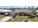 Inviting home featuring a tile roof, attached garage, and manicured lawn in a desirable neighborhood at 944 Genoa Ct, Punta Gorda, FL 33950