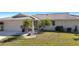 Charming single-story home with a well-maintained lawn and beautiful landscaping, including palm trees at 944 Genoa Ct, Punta Gorda, FL 33950