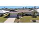 Charming single-story home featuring a well-manicured lawn and a spacious driveway at 944 Genoa Ct, Punta Gorda, FL 33950