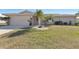 Charming single-story home with a well-manicured lawn and tropical landscaping, creating curb appeal at 944 Genoa Ct, Punta Gorda, FL 33950