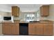 Kitchen area featuring granite countertops and a black dishwasher at 944 Genoa Ct, Punta Gorda, FL 33950