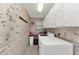 Functional laundry room with modern white appliances, ample storage cabinets, and a practical countertop space at 944 Genoa Ct, Punta Gorda, FL 33950