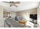 Inviting living room featuring tile floors, a ceiling fan, and a cozy seating arrangement at 944 Genoa Ct, Punta Gorda, FL 33950