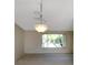 Open-plan living room with modern chandelier and large windows offering natural light at 944 Genoa Ct, Punta Gorda, FL 33950