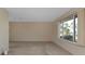 Open area showing the living room with tan walls and light streaming in from the window at 944 Genoa Ct, Punta Gorda, FL 33950