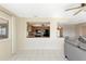 View of living room, featuring breakfast bar into the kitchen, and lots of light from the windows at 944 Genoa Ct, Punta Gorda, FL 33950