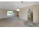 Bright living room with window views and adjacent entry to kitchen area at 944 Genoa Ct, Punta Gorda, FL 33950