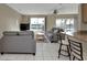Comfortable living room featuring tile flooring, gray couches, and views of the canal at 944 Genoa Ct, Punta Gorda, FL 33950