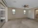 This spacious main bedroom has a ceiling fan and sliding glass door for natural light at 944 Genoa Ct, Punta Gorda, FL 33950