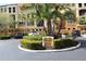Exterior view of the building with landscaping, palm trees, and designated parking at 99 Vivante Blvd # 404, Punta Gorda, FL 33950