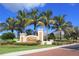 Inviting community entrance with palm trees and attractive landscaping at 99 Vivante Blvd # 404, Punta Gorda, FL 33950