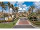 Inviting community entrance with palm trees and lush landscaping at 99 Vivante Blvd # 404, Punta Gorda, FL 33950