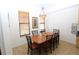 Cozy dining room with a wooden table set for six, chandelier, and natural light at 99 Vivante Blvd # 404, Punta Gorda, FL 33950