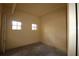 Empty garage space featuring unfinished concrete floor, beige painted walls, and natural light at 99 Vivante Blvd # 404, Punta Gorda, FL 33950