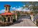 Secure gatehouse entrance to community with lush landscaping and red tile roofs at 99 Vivante Blvd # 404, Punta Gorda, FL 33950