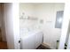 Bright laundry room with washer, dryer, shelving, and neutral wall paint at 99 Vivante Blvd # 404, Punta Gorda, FL 33950