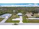 Aerial view of a single-story home with lush greenery in a quiet neighborhood at 1027 Campbell St, Port Charlotte, FL 33953