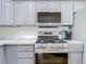 Updated kitchen features gray cabinets, stainless steel appliances, and white subway tile backsplash at 1027 Campbell St, Port Charlotte, FL 33953