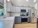 Modern kitchen with stainless steel appliances, granite countertops, and gray cabinets at 1027 Campbell St, Port Charlotte, FL 33953
