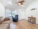 Bright living room with vaulted ceiling, hardwood floors, and large windows for natural light at 1027 Campbell St, Port Charlotte, FL 33953
