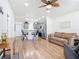 Open-concept living room featuring hardwood floors, a ceiling fan, and comfortable seating at 1027 Campbell St, Port Charlotte, FL 33953