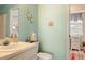 Bright bathroom with a toilet, sink, and vanity with a mirror and coastal-themed decorations that add character at 12107 Gulfstream Blvd, Port Charlotte, FL 33981