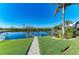 Lush landscaping and backyard lead to a personal boat lift and direct water access at 1368 Grebe Dr, Punta Gorda, FL 33950